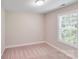 Cozy bedroom with a neutral carpet and a bright window at 115 Dove Sw Ave, Concord, NC 28025