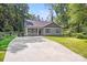 Charming home with gray siding, well-manicured lawn, and a spacious driveway at 115 Dove Sw Ave, Concord, NC 28025