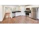 Modern kitchen with stainless steel appliances, white cabinets, and a seamless flow into the living area at 115 Dove Sw Ave, Concord, NC 28025
