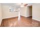 Open-concept living area with modern flooring, ceiling fan, neutral walls and easy access to the kitchen at 115 Dove Sw Ave, Concord, NC 28025