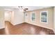 Bright living room offers sleek flooring, natural light, and a ceiling fan at 115 Dove Sw Ave, Concord, NC 28025