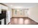 The spacious living area is well-lit with natural light and has wood-look floors at 115 Dove Sw Ave, Concord, NC 28025