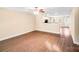 Bright living room featuring wood-look floors, ceiling fan, neutral walls, and easy access to the kitchen at 115 Dove Sw Ave, Concord, NC 28025