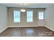 Bright living room area with windows, leading to outdoor access at 115 Dove Sw Ave, Concord, NC 28025