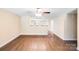 Open-concept living space with modern flooring, ceiling fan, neutral walls, and open access to the kitchen at 115 Dove Sw Ave, Concord, NC 28025