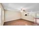Bright and airy living room with light walls, wood floors, ceiling fan, and open access to the kitchen at 115 Dove Sw Ave, Concord, NC 28025