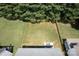 Aerial view of a large grassy backyard with patio and outdoor dining set at 12341 Mcallister Park Dr, Charlotte, NC 28277
