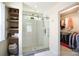 Bathroom showcasing a glass-enclosed shower, rain shower head, and custom closet at 12341 Mcallister Park Dr, Charlotte, NC 28277