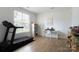 Bright, airy bedroom featuring a treadmill, desk, keyboard, and large windows at 12341 Mcallister Park Dr, Charlotte, NC 28277