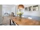Dining room with hardwood floors, wooden table, and large windows at 12341 Mcallister Park Dr, Charlotte, NC 28277