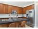 Charming kitchen with wooden cabinets, stainless steel appliances, and a functional island with seating at 12341 Mcallister Park Dr, Charlotte, NC 28277
