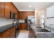 Well-lit kitchen features wood cabinets, stainless steel appliances, and a functional layout at 12341 Mcallister Park Dr, Charlotte, NC 28277