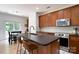Spacious kitchen with dark countertops, stainless steel appliances, and an island with barstool seating at 12341 Mcallister Park Dr, Charlotte, NC 28277