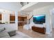 Open-concept living room showing stairs to second level, kitchen and TV at 12341 Mcallister Park Dr, Charlotte, NC 28277
