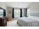 A spacious bedroom features neutral paint, tray ceilings, two windows with seating, and a view to outside nature at 12341 Mcallister Park Dr, Charlotte, NC 28277