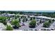 Aerial view of complex's parking lot surrounded by trees and local amenities at 1300 Reece Rd # 305, Charlotte, NC 28209