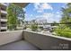 A balcony overlooking a street with townhomes and greenery at 1300 Reece Rd # 305, Charlotte, NC 28209