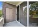 Balcony with sliding glass doors and a view of trees at 1300 Reece Rd # 305, Charlotte, NC 28209