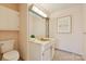 Bathroom with white cabinets, neutral countertop and tile flooring at 1300 Reece Rd # 305, Charlotte, NC 28209