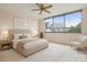 Bedroom with large window and lots of natural light, neutral paint, and standard ceiling fan at 1300 Reece Rd # 305, Charlotte, NC 28209