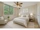 Comfortable bedroom featuring large window, neutral paint, and standard ceiling fan at 1300 Reece Rd # 305, Charlotte, NC 28209