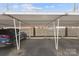 Covered parking carport area showcasing a parked blue vehicle at 1300 Reece Rd # 305, Charlotte, NC 28209