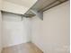 Walk-in closet with metal racks and neutral carpeting at 1300 Reece Rd # 305, Charlotte, NC 28209