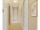 Inviting hallway with neutral paint, carpet flooring, and decorative art at 1300 Reece Rd # 305, Charlotte, NC 28209