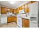 Traditional kitchen with oak cabinets, laminate countertop, and appliances at 1300 Reece Rd # 305, Charlotte, NC 28209
