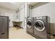 A laundry room with multiple washing machines and a folding table at 1300 Reece Rd # 305, Charlotte, NC 28209