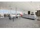 A recreation room with a ping pong table, sofas, tables, and large windows at 1300 Reece Rd # 305, Charlotte, NC 28209