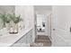 A large double vanity with wood look flooring and a doorway to bedroom can be seen at 1339 37Th Avenue Ne Ln, Hickory, NC 28601