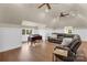 Cozy attic living room features comfortable leather seating, a home office desk, and natural light from the windows at 1430 Rosehill Dr, Waxhaw, NC 28173