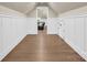Spacious attic hallway featuring hardwood floors, crisp white trim, with a view of the living area and ample storage space at 1430 Rosehill Dr, Waxhaw, NC 28173