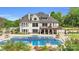 Luxury home with a beautiful outdoor swimming pool, spa, and a covered veranda for outdoor living at 1430 Rosehill Dr, Waxhaw, NC 28173