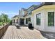 Expansive backyard deck showcases a white brick home exterior, a seating area, and a serene outdoor grilling space at 1430 Rosehill Dr, Waxhaw, NC 28173