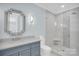 Stylish bathroom with a modern vanity, large mirror, and glass-enclosed shower at 1430 Rosehill Dr, Waxhaw, NC 28173