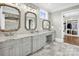 Luxury bathroom with double vanity, framed mirrors, and a walk-in closet at 1430 Rosehill Dr, Waxhaw, NC 28173