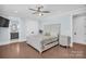 Bright bedroom with light blue walls, hardwood floors, and a ceiling fan at 1430 Rosehill Dr, Waxhaw, NC 28173