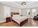 Cozy bedroom with hardwood floors, natural light from windows, and a dark wooden bed frame at 1430 Rosehill Dr, Waxhaw, NC 28173