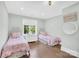 Charming bedroom with twin beds, pastel decor, and a bright window view at 1430 Rosehill Dr, Waxhaw, NC 28173