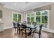 Open dining room with a modern chandelier and large windows overlooking the backyard at 1430 Rosehill Dr, Waxhaw, NC 28173