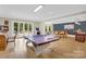 Large game room with ping pong table, arcade game, and poker table with wet bar at 1430 Rosehill Dr, Waxhaw, NC 28173