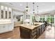 Gourmet kitchen features a large island, pendant lighting, and views into the living and dining areas at 1430 Rosehill Dr, Waxhaw, NC 28173