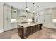 Bright kitchen features an island with seating, pendant lighting, and custom cabinetry at 1430 Rosehill Dr, Waxhaw, NC 28173