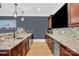 Open kitchenette with granite countertops, stainless appliances, and wood cabinetry at 1430 Rosehill Dr, Waxhaw, NC 28173