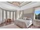 Serene main bedroom featuring a tray ceiling, bay window, and a sitting area at 1430 Rosehill Dr, Waxhaw, NC 28173