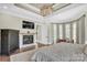 Inviting main bedroom features a fireplace, hardwood floors, and a sitting area at 1430 Rosehill Dr, Waxhaw, NC 28173