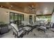 Covered patio with seating and ceiling fan overlooking the serene backyard at 1430 Rosehill Dr, Waxhaw, NC 28173