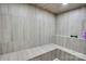 Tranquil steam room with sleek tiled walls, built-in bench seating, and a minimalist design for relaxation at 1430 Rosehill Dr, Waxhaw, NC 28173